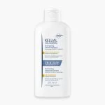 Flacon blanc Ducray Kelual Squanorm shampooing pellicules sèches 200 ml