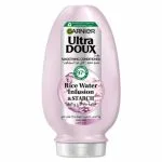 Flacon rose Garnier Ultra Doux après-shampoing lissant eau de riz et amidon