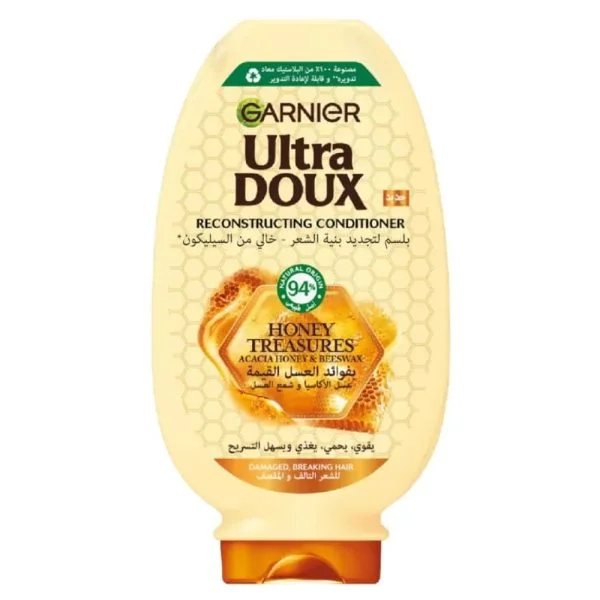 Flacon ambré Garnier Ultra Doux après-shampoing Trésor de Miel acacia et cire