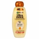 Flacon doré Garnier Ultra Doux shampooing reconstituant Trésors de Miel