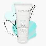 Tube blanc Héliabrine O-Regen crème exfoliante visage 75 ml, fond turquoise
