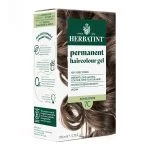 Boîte Herbatint coloration permanente 7C blond cendré avec cheveux châtain cendré bouclés