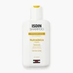 Flacon blanc ISDIN Shampoo Nutradeica pellicules sèches 200 ml, bandeau jaune