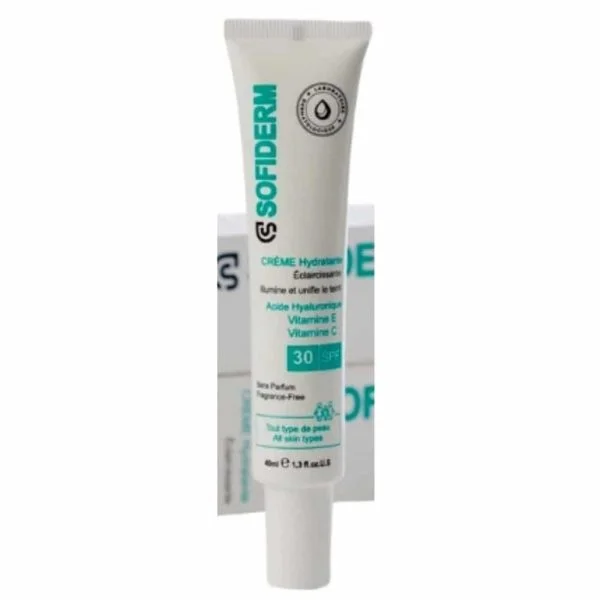 Tube blanc Sofiderm crème hydratante éclaircissante SPF 30 devant son étui