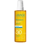 Flacon spray doré Uriage Bariésun huile sèche SPF30 200 ml